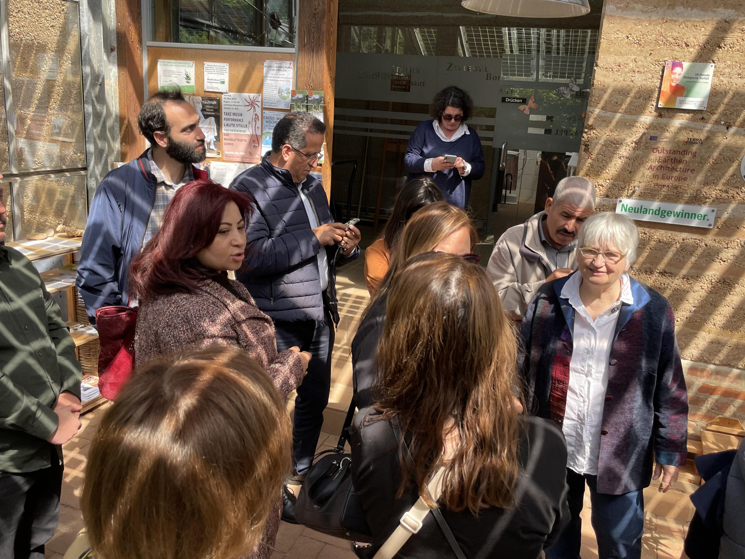 Delegation vor dem Lehmhaus des Wangeliner Gartens